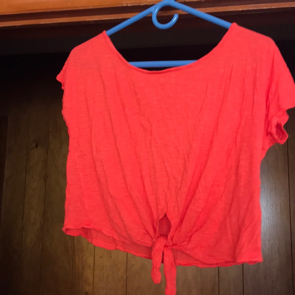 An bright orange colored crop top.